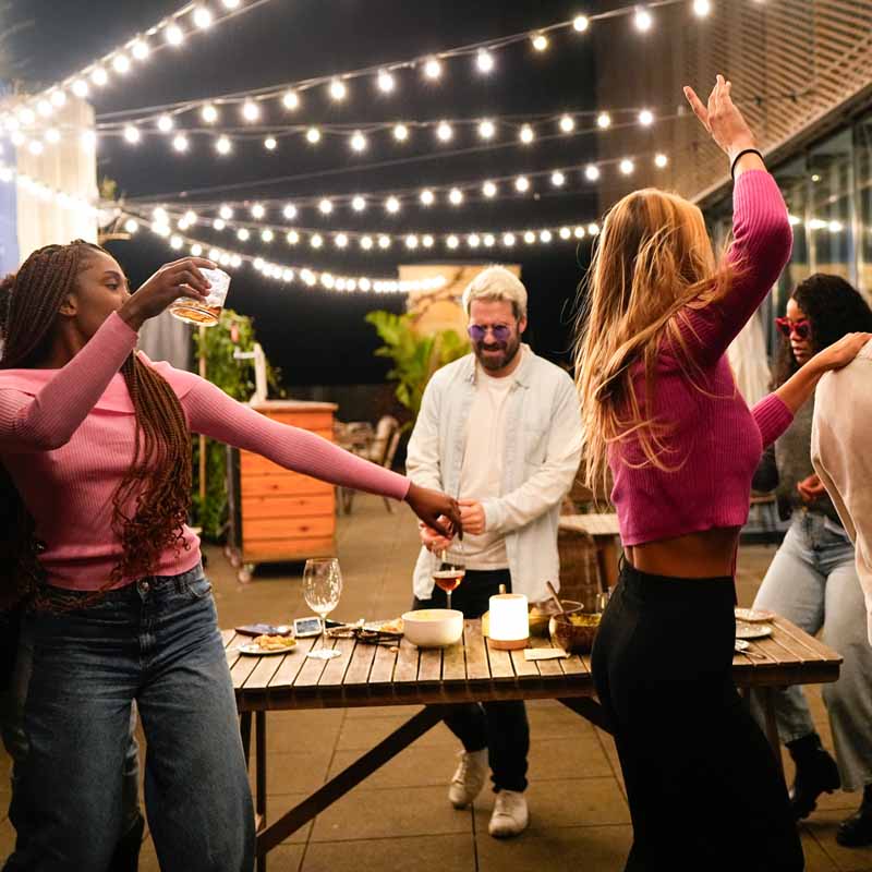 People celebrating with Live Fire cooking and drinks